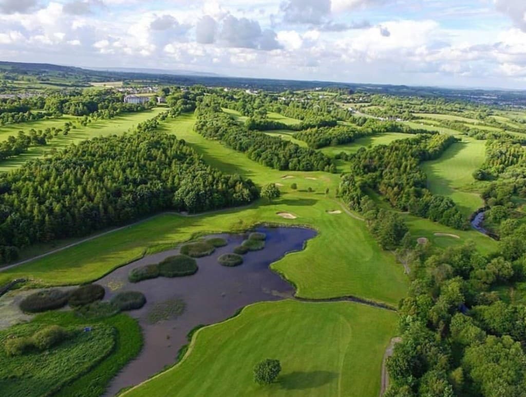 Parkland fairways and water at Woodstock Golf Club